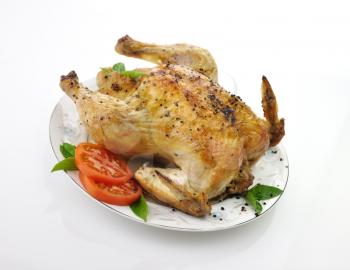 Roasted chicken with fresh tomatoes and basil leaves