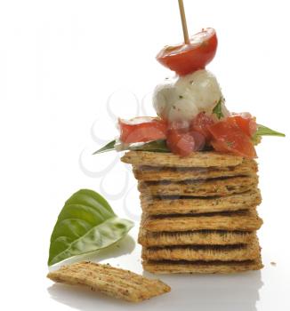 Whole Wheat Cracker Appetizer With Tomatoes ,Mozzarella Cheese And Spices