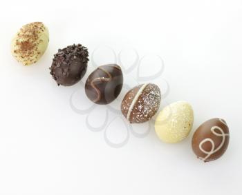 assortment of chocolate eggs on white background