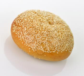 Fresh tasty roll with sesame, on white background