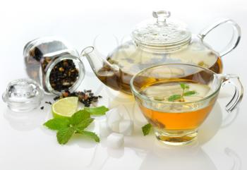green tea composition with teapot,cup ,lime and peppermint