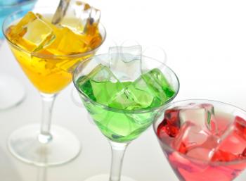 glasses of colorful cold drinks , close up
