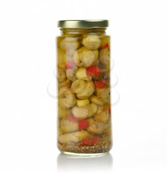Glass jar of preserved mushrooms with red pepper