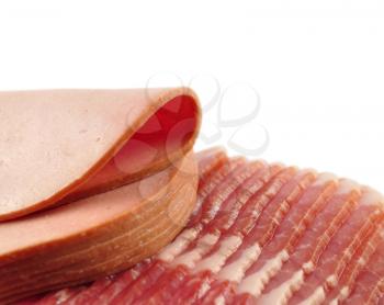Bacon and sausage  slices on white background , close up shot