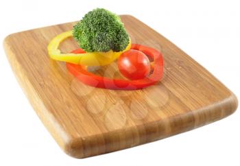 fresh vegetables on a cutting board on white background