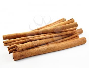 a stack of cinnamon sticks on white background