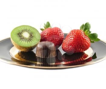 kiwi ,strawberry and chocolate candy on a plate