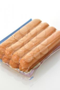 sausages in a plastic package on a white background