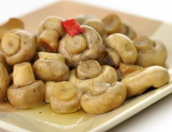 pickled mushrooms with red pepper on a plate