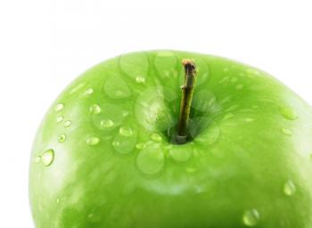 a green apple with water drops , close up