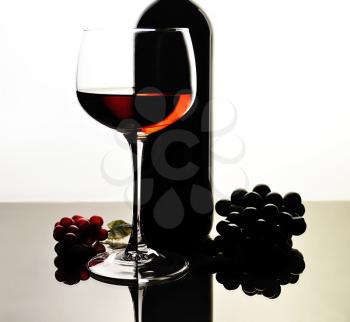 red wine glass and bottle  with reflection 