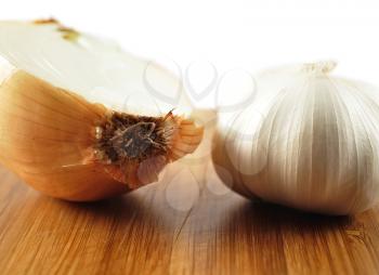 garlic and onion on a cutting board, close up