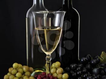 white wine and grape on black background
