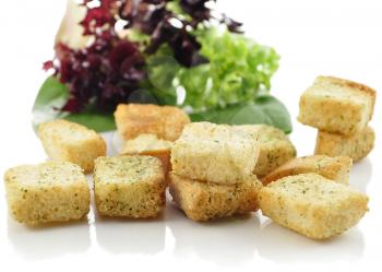 seasoned croutons and salad leaves , close up