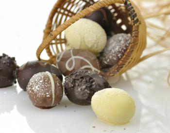 assortment of chocolate eggs and  a basket, close up