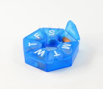 a blue pill box on white background