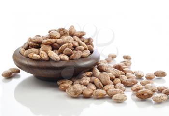 raw beans in a bowl on white background