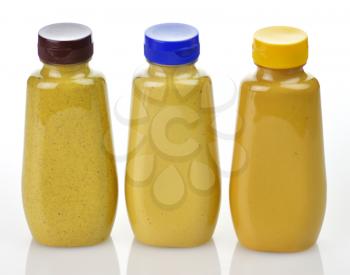 plastic  bottles of honey ,dijon and spicy brown mustard