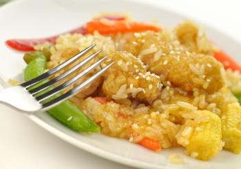 white meat chicken with rice ,vegetables and sesame seeds in a mandarin sauce 
