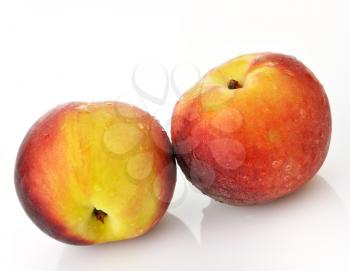 fresh peaches with waterdrops on white background