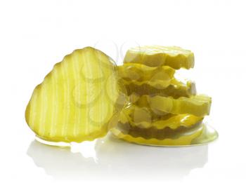 a stack of pickle slices on white background