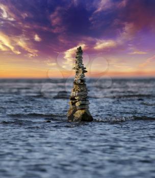 Stack Of Stones On The Water Against A Sunset