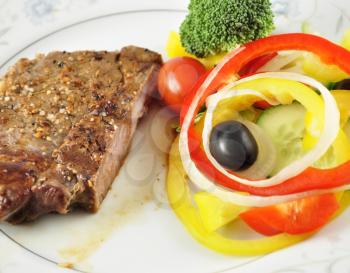 a steak and fresh vegetables, close up