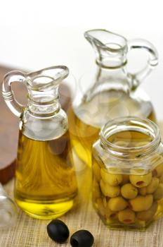 bottles of olive oil with black and green olives