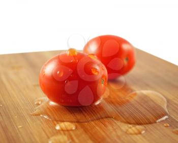 small cherry tomatoes on a cutting board