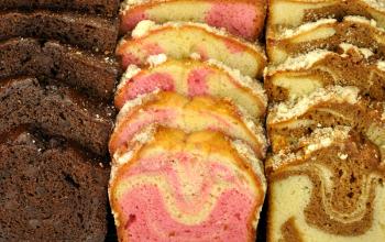 assortment of loaf cake slices , double chocolate ,raspberry swirl and cinnamon swirl. 