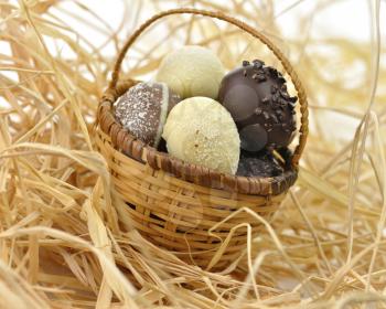 assortment of chocolate eggs in a basket, close up