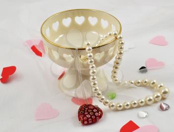 pearl and silver necklaces in a decorative vase