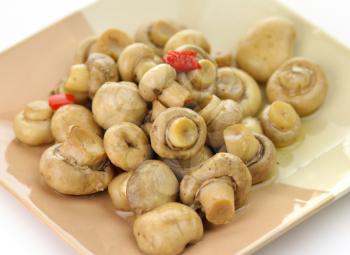 pickled mushrooms with red pepper on a plate