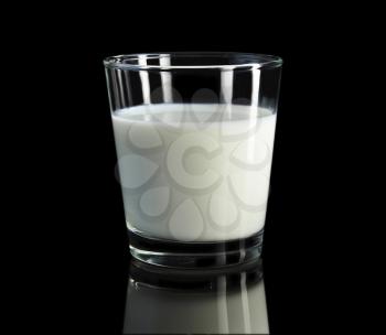 a glass of milk on black  background