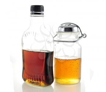 maple syrup and honey in glass bottles
