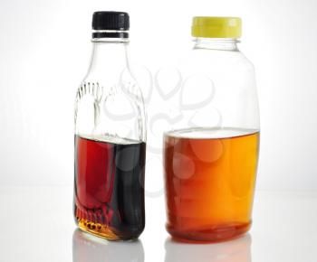 bottles with maple syrup and honey 
