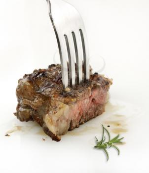 Piece Of Red  Meat Steak On A Fork,Close Up