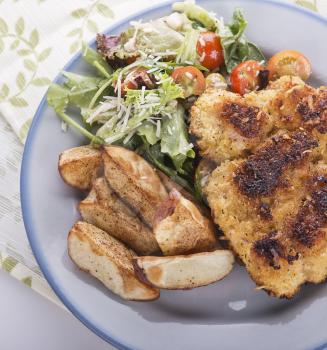Schnitzel with potatoes and salad, top view