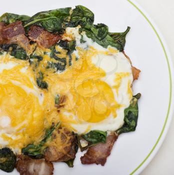Keto diet breakfast with  eggs, spinach and bacon.Low carb high fat breakfast.