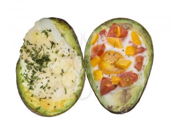 Baked avocado with eggs , cheese and vegetables isolated on white background