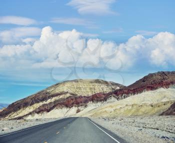 Desert road leading through Death Valley National Park, California USA.