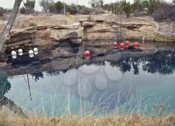 SANTA ROSA, NM, USA - March 11 ,2019. At 80 feet deep with clear blue water, the Blue Hole on Route 66 in Santa Rosa, NM. The Blue Hole of Santa Rosa is a circular, bell-shaped pool east of Santa Rosa