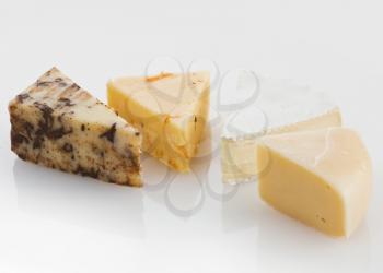 Variety of Cheese Slices On White Background
