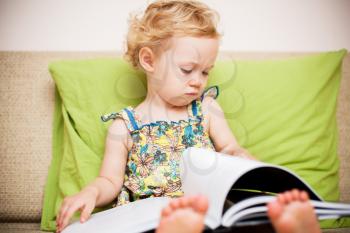 Baby girl reading a book 