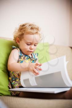 Baby girl reading a book