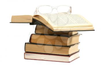 Books with glasses isolated on white 