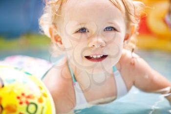 Little blondie girl in the swimming pool