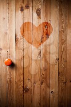 Wooden door with red heart in the middle