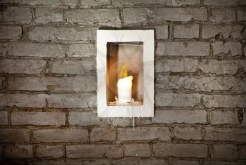Old brick wall background, candle in the middle