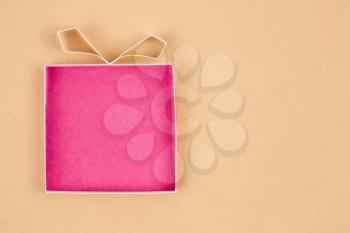 Hand made empty gift box, textured paper as background. Free space for text. Greeting card 